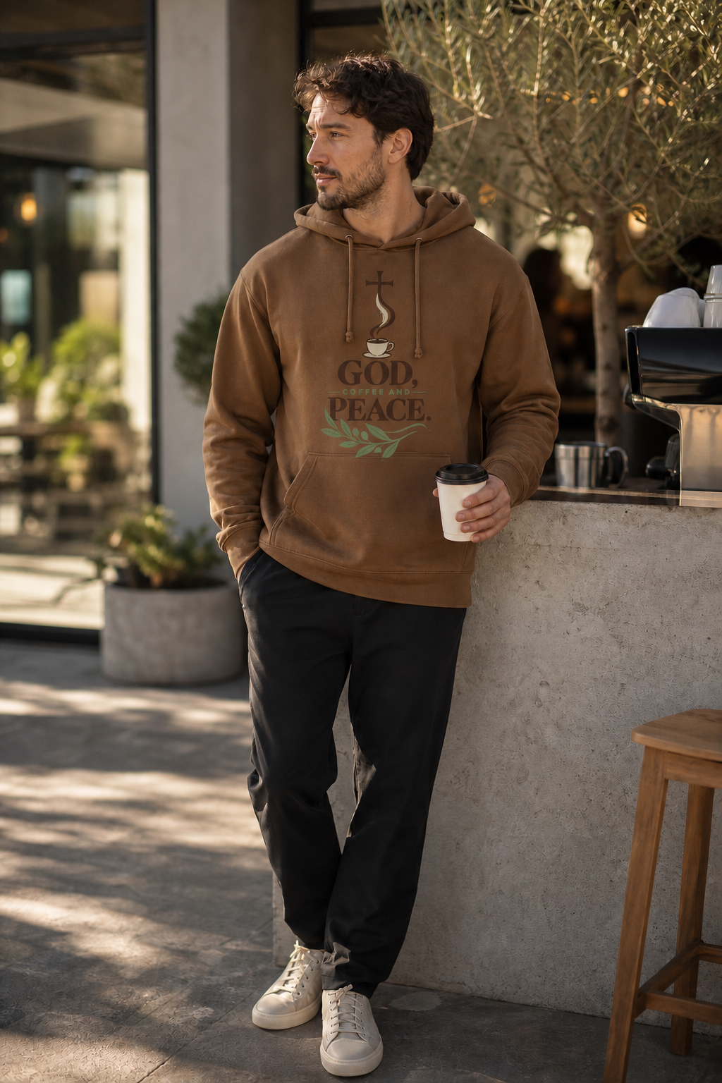 Man wearing the God Coffee and Peace hoodie outdoors
