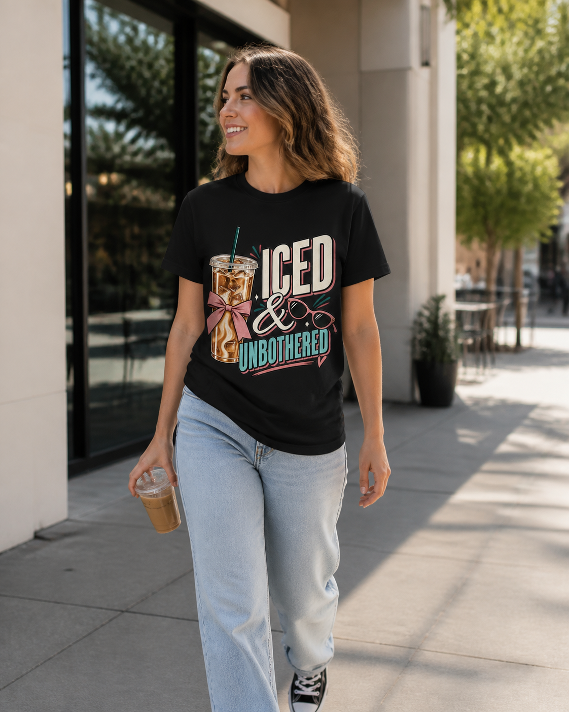 Woman wearing the Iced and Unbothered tee outdoors