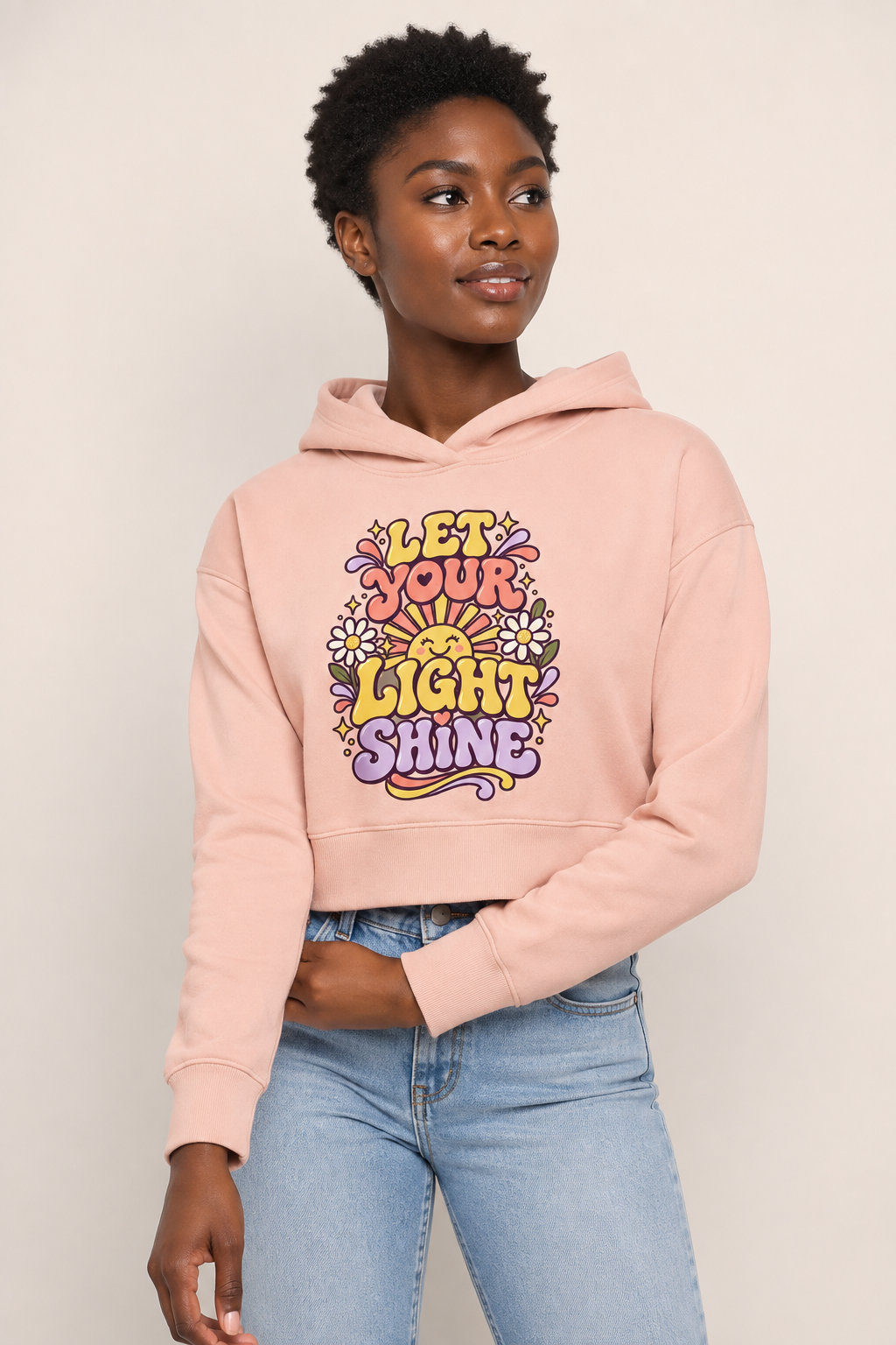 Black woman wearing the Let Your Light Shine cropped hoodie in studio