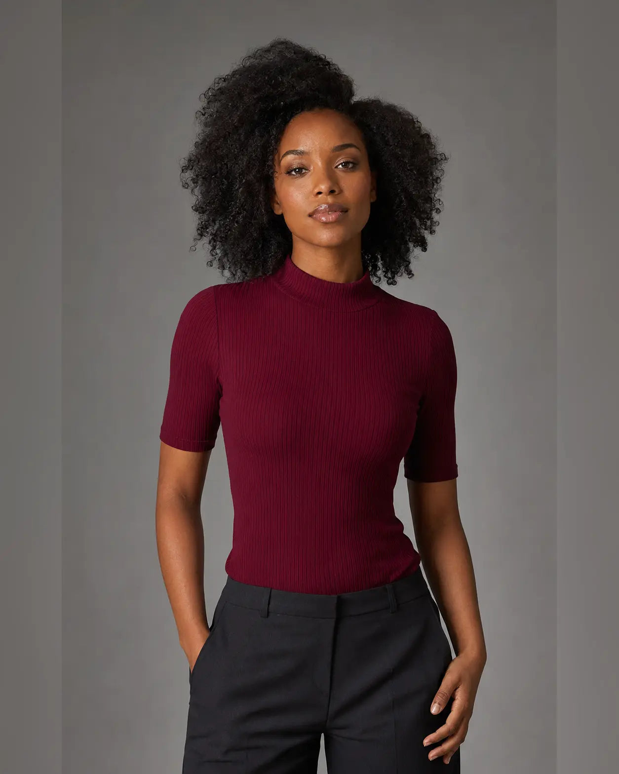 Woman wearing a wine ribbed top