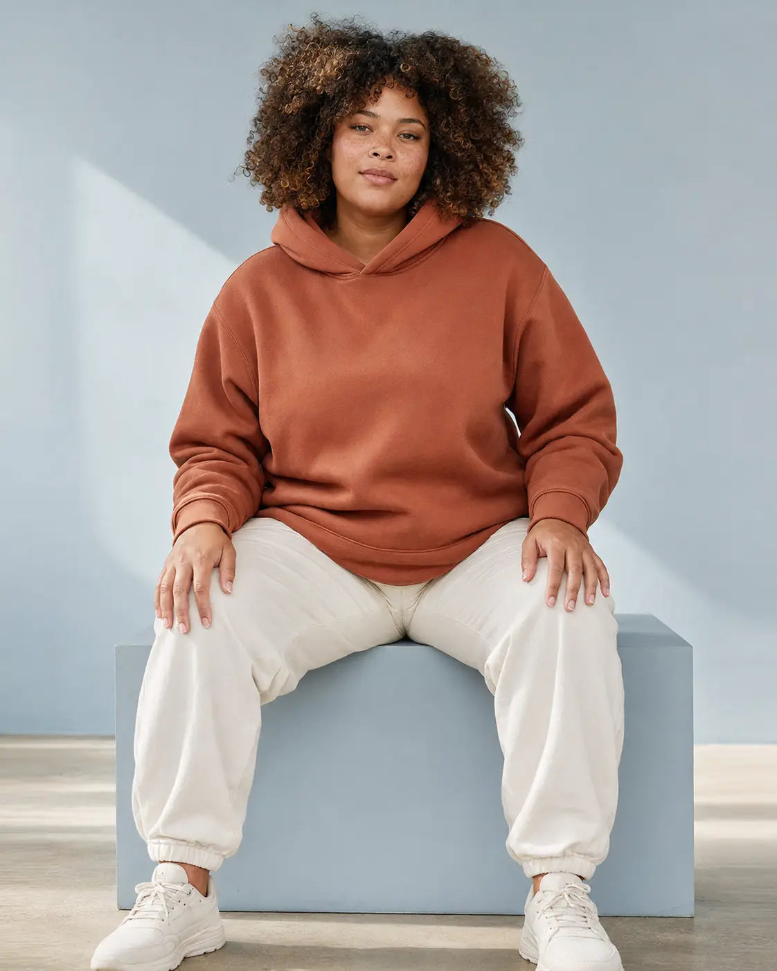 Woman wearing a clay pullover hoodie