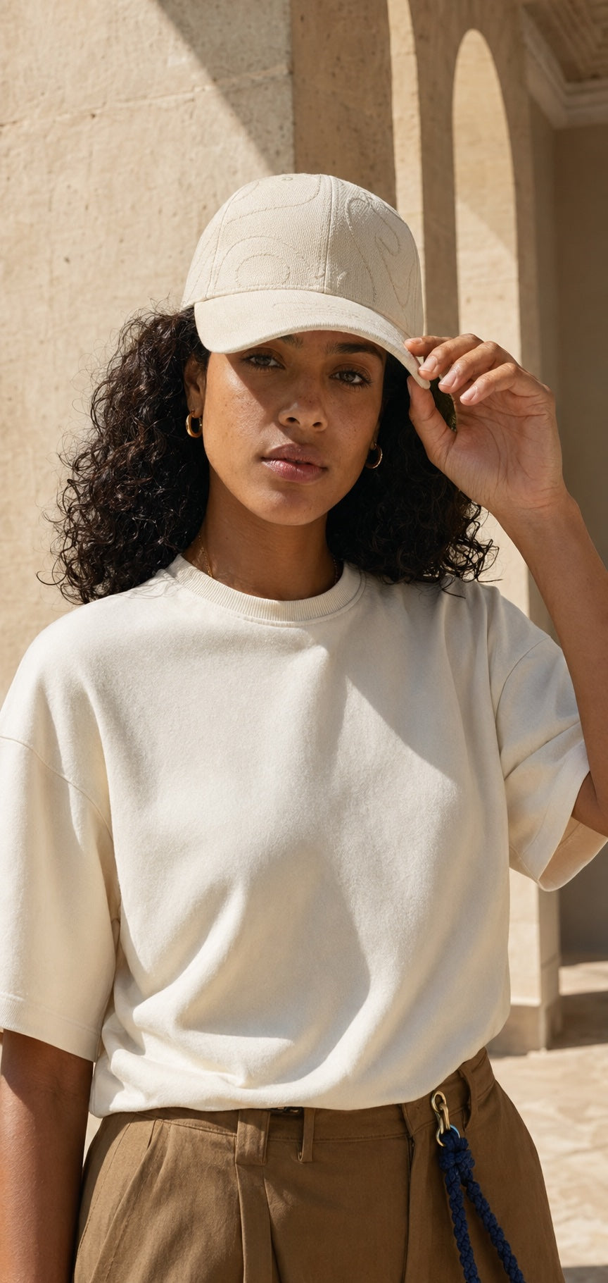 Woman wearing a premium blank tee and embroidered cap